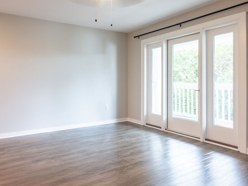 Empty Living Room with balcony doors in 2 bedroom unit